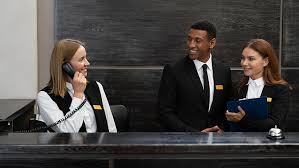 three people wearing suits discussing in the hotel