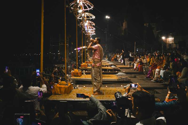 "Evening Ganga Aarti ceremony at Dashashwamedh Ghat Varanasi with lamps and devotees"